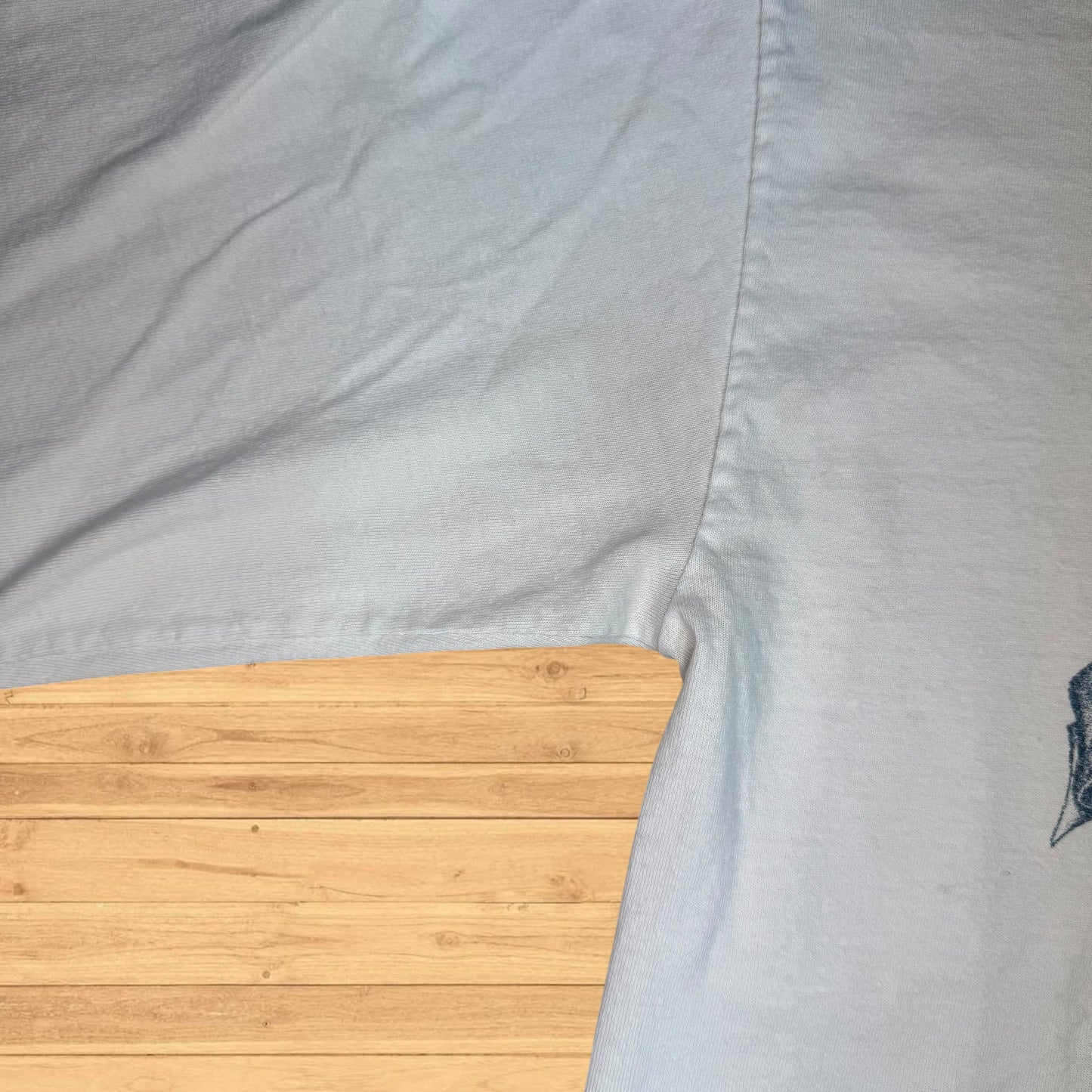 Close-up of a gray fabric with a wooden surface underneath