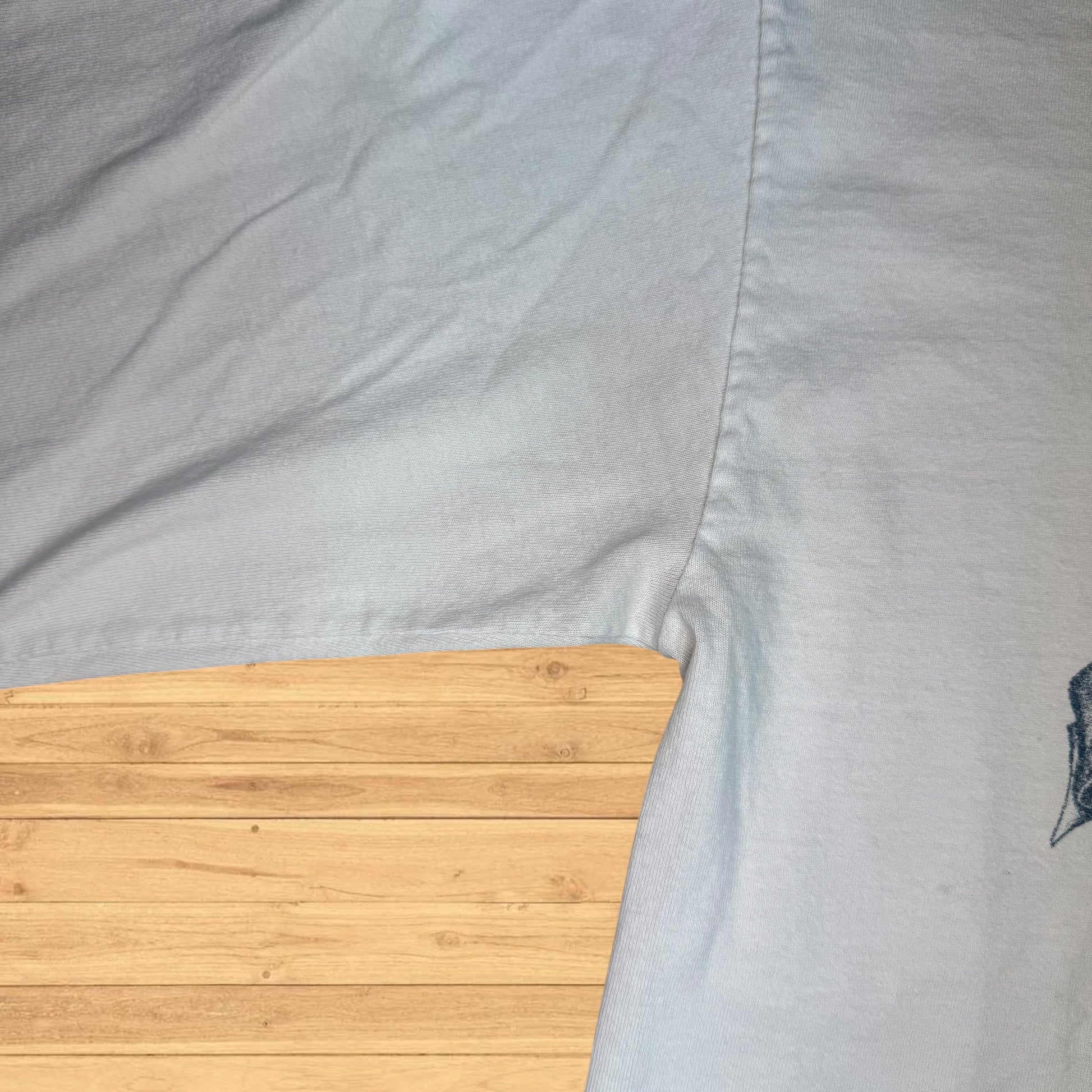 Close-up of a gray fabric with a wooden surface underneath